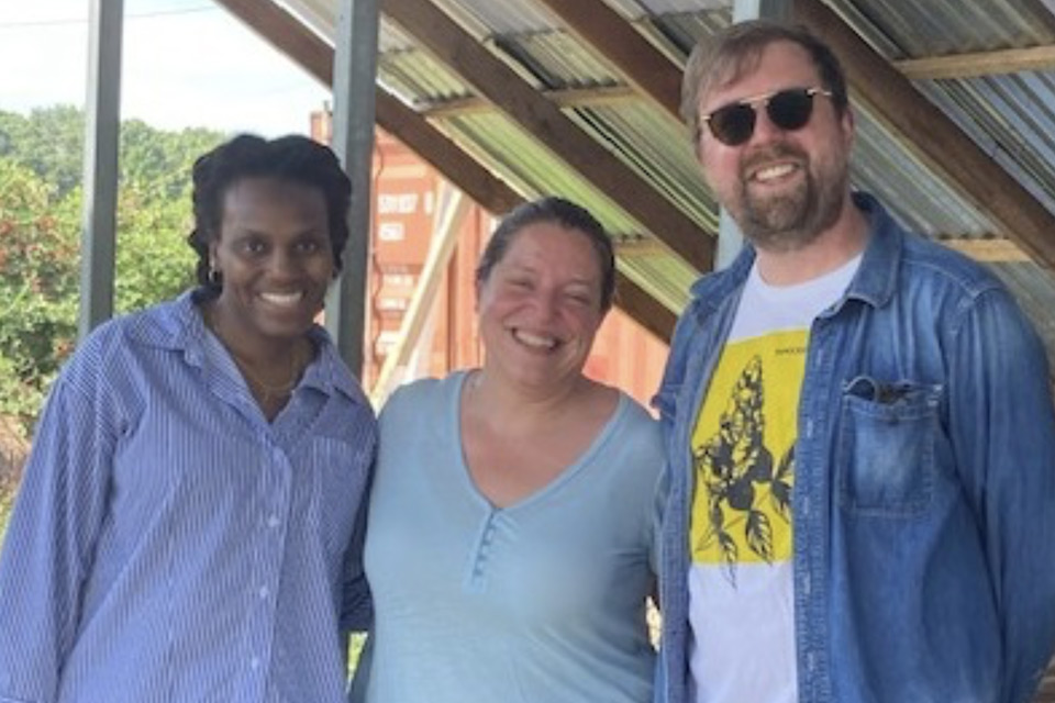 Three artists standing next to each other