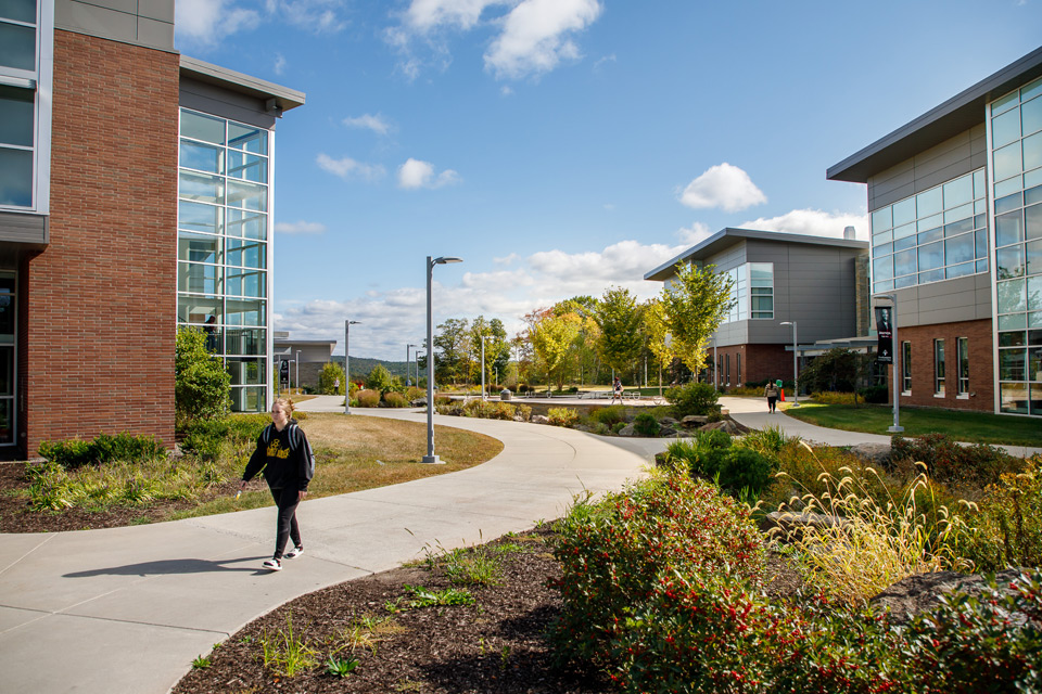 Female student walking across Pocono campus