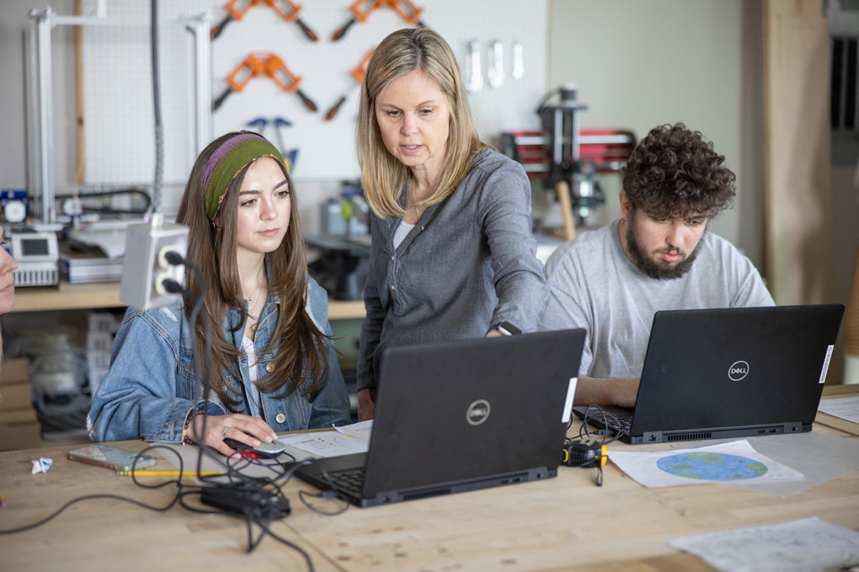Instructor assisting a male and female students