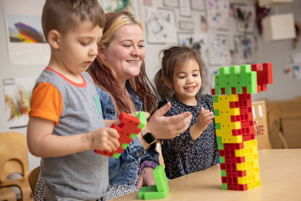 student working with children in daycare