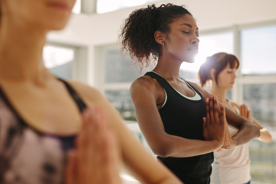 Female students practicing breathing techniques in yoga